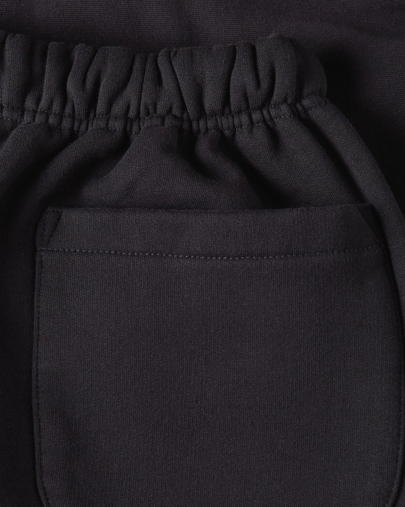 Close-up of the elastic waistband and rear pocket on the black Patta Classic Jogging Shorts.