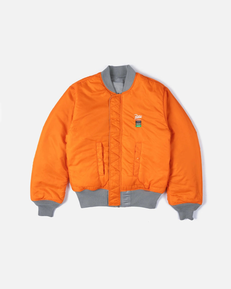 Patta x Alpha Industries MA-1 Celebration bomber jacket reversed in bright orange with grey trim.