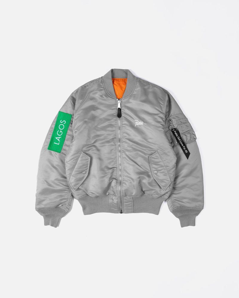 Patta x Alpha Industries silver MA-1 bomber jacket with orange lining and Lagos sleeve patch.