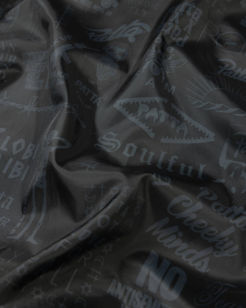 Black printed inner lining of the Patta x Avirex Icon Jacket with tonal archival graphics.