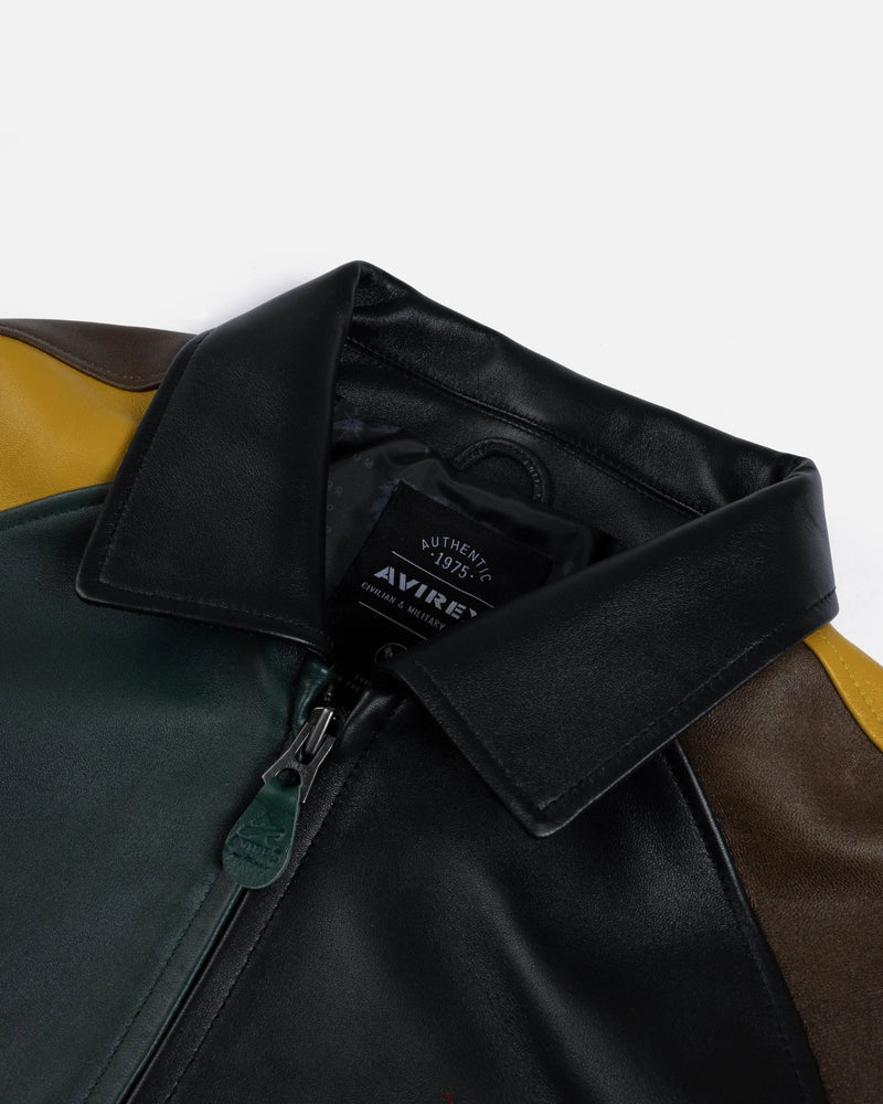 Close-up of the black leather collar, zipper, and neck label on the multicolor Patta x Avirex Icon Jacket.