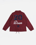 Back view of the garnet Patta x Converse coaches jacket with 20 Down anniversary graphic print.
