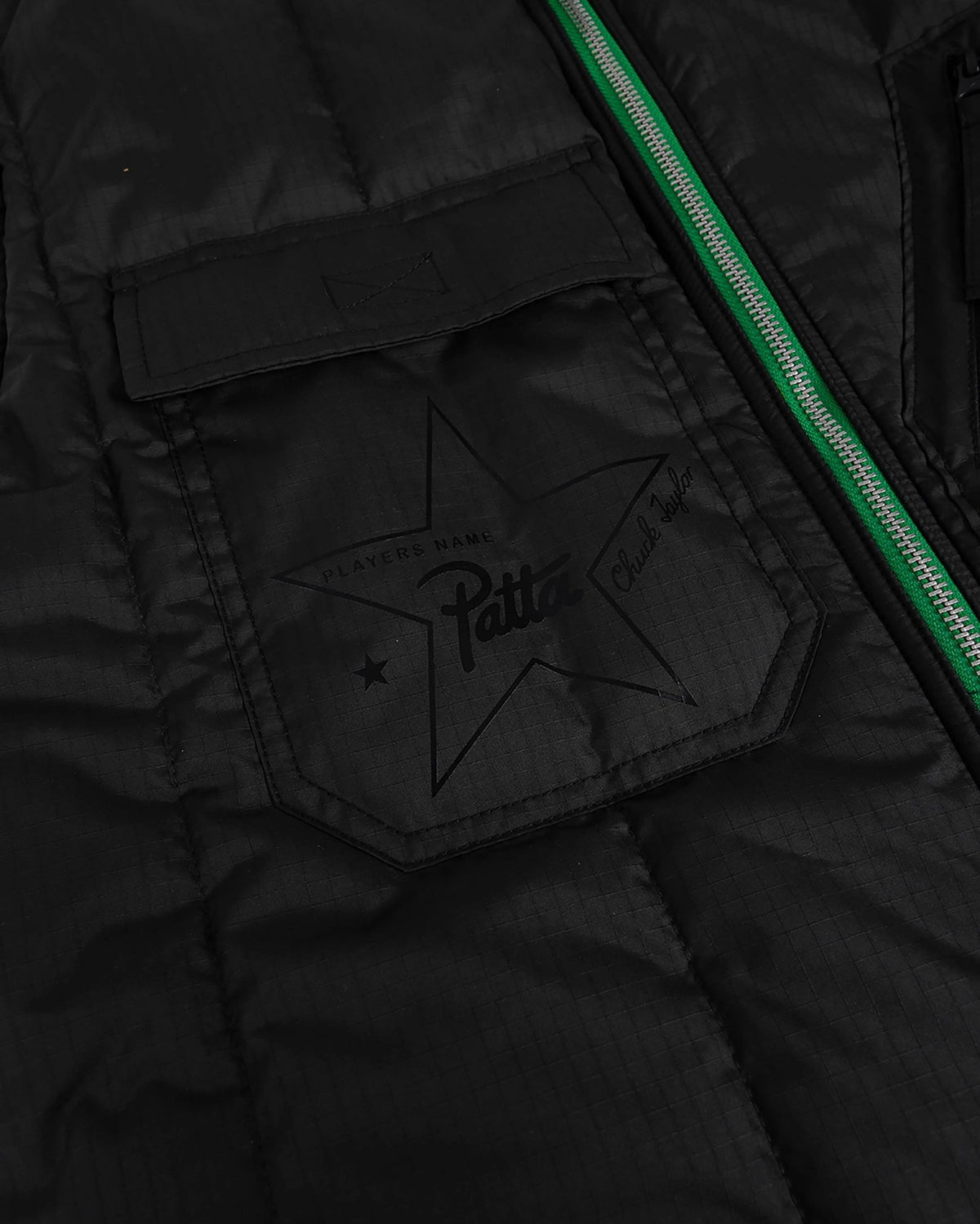 Close-up of the black ripstop pocket with star graphic on the Patta x Converse Reversible Vest.