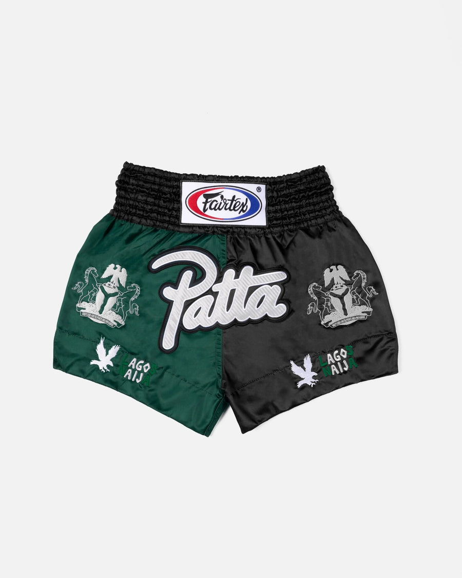 Patta x Fairtex Muay Thai shorts in split green and black satin with embroidered branding.
