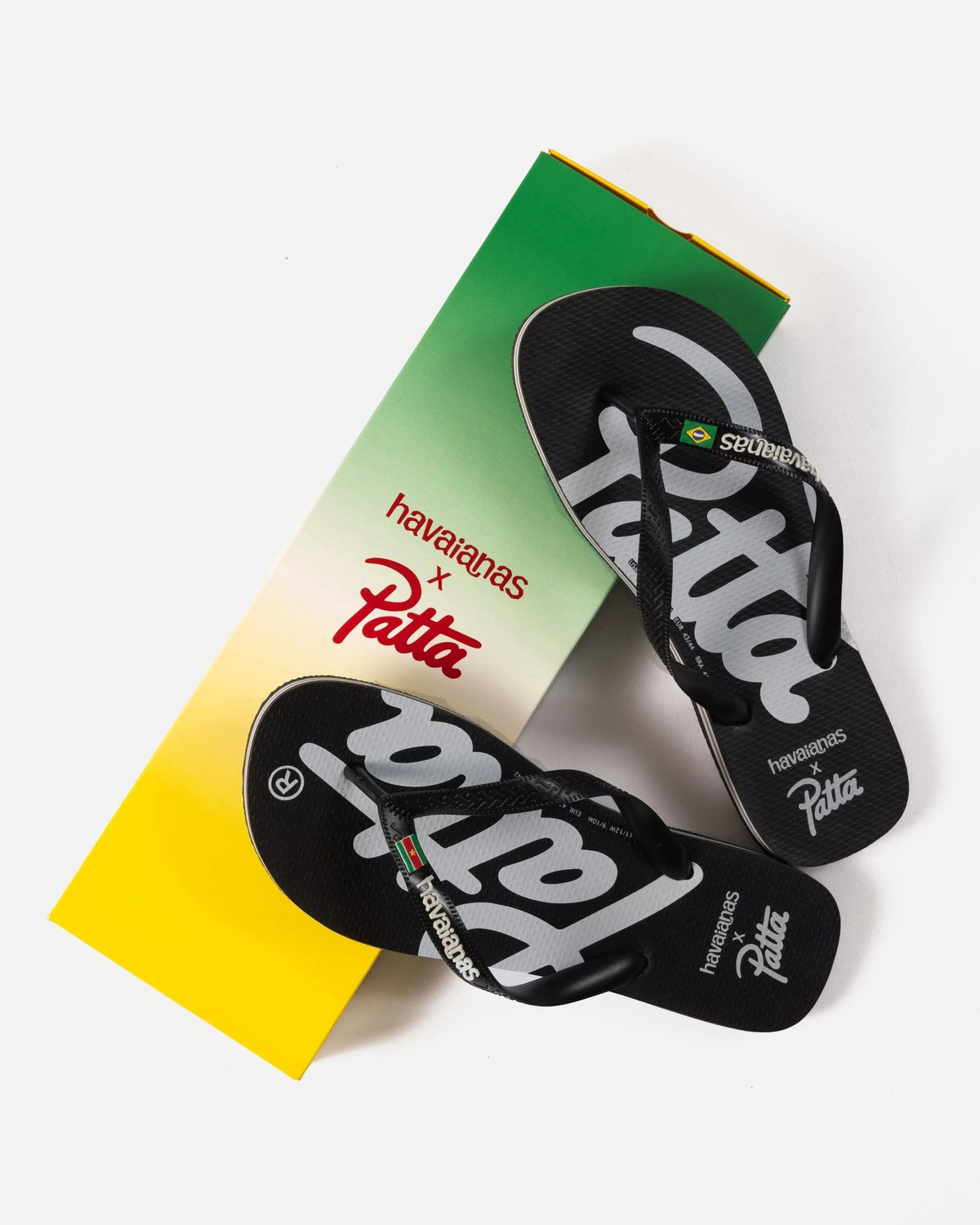 Patta x Havaianas Top black flip-flops displayed on their custom green and yellow box.