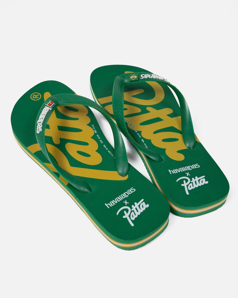 Green Patta x Havaianas flip-flops featuring yellow logo script on the footbeds and rubber straps.