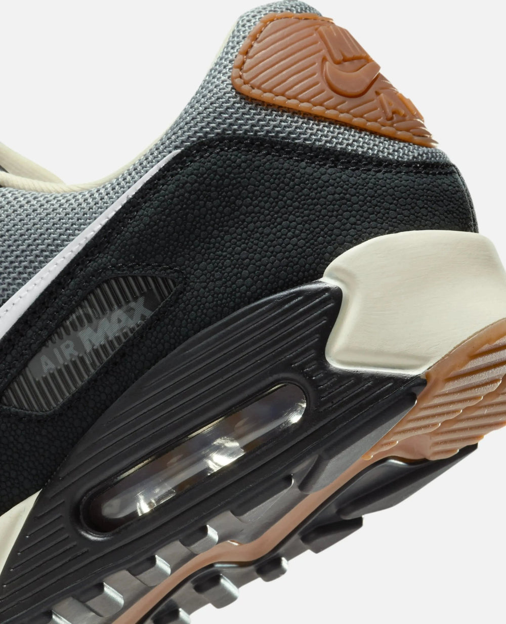 Heel detail of Patta x Nike Air Max 90 SP sneaker showing the visible Air unit and textured black paneling.