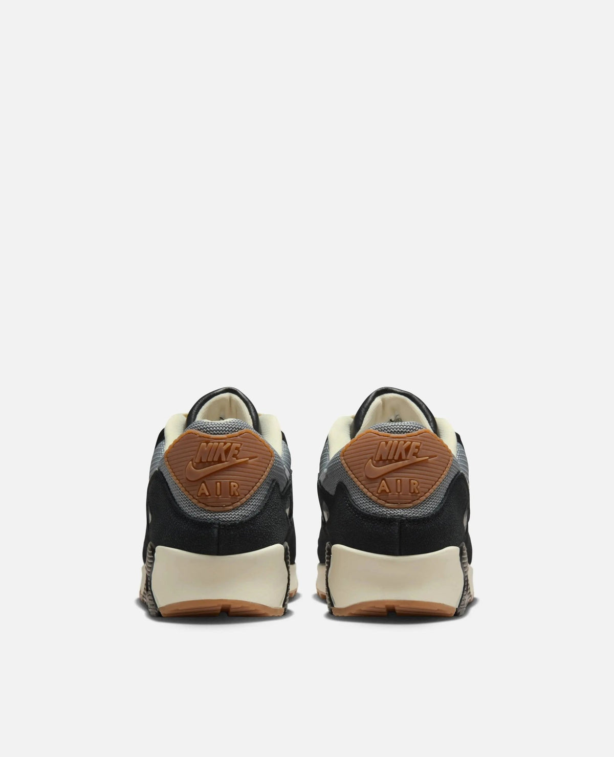 Rear view of Patta x Nike Air Max 90 SP sneakers in black and particle grey with brown Nike Air tabs.