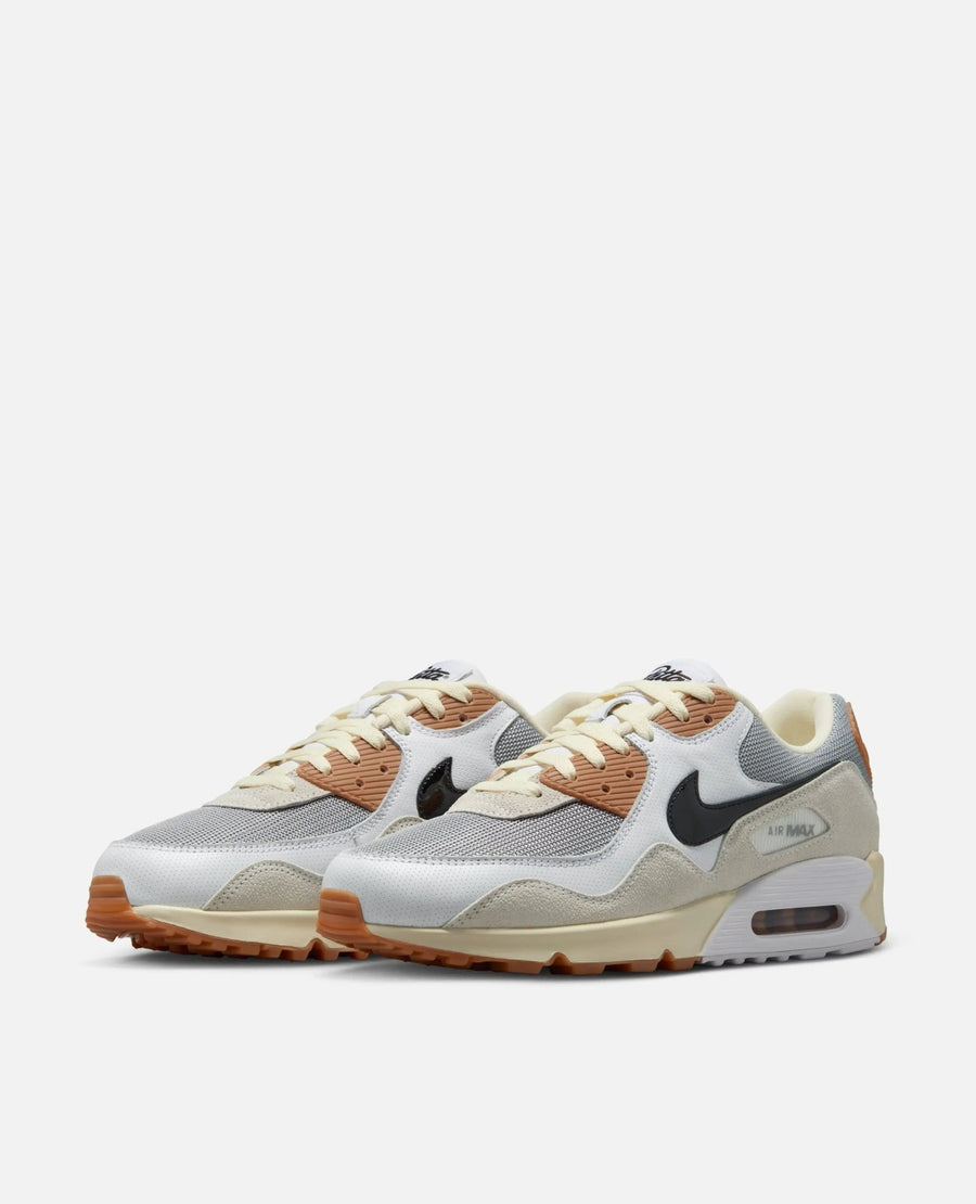 Patta x Nike Air Max 90 SP sneakers in particle grey, black, and coconut milk from a front three-quarter angle.