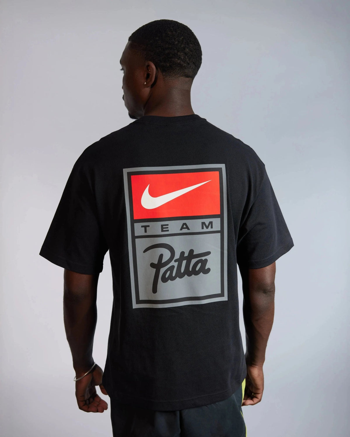 Back view of the black Patta x Nike NRG T-shirt with graphic Team Patta box logo on a model.