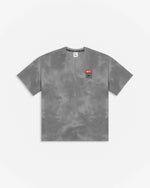 Patta x Nike NRG washed grey tie-dye T-shirt with chest badge against a plain white background.