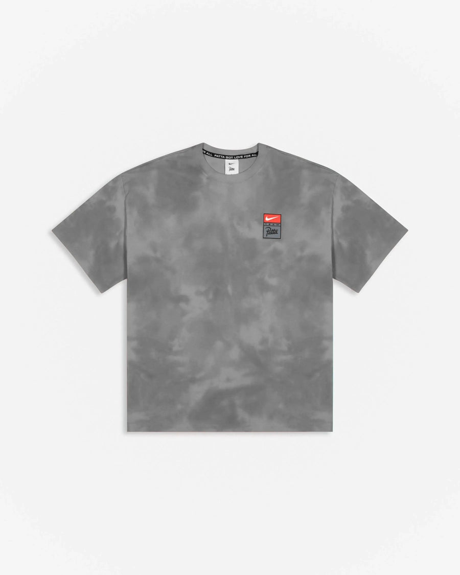 Patta x Nike NRG washed grey tie-dye T-shirt with chest badge against a plain white background.