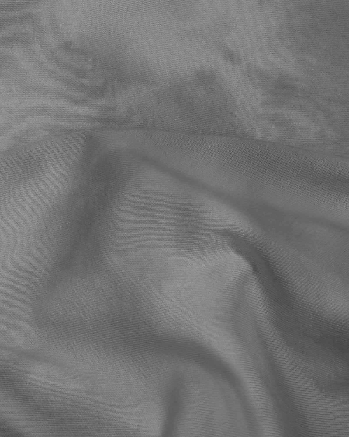 Close-up of grey washed cotton jersey fabric texture on the Patta x Nike NRG T-shirt.