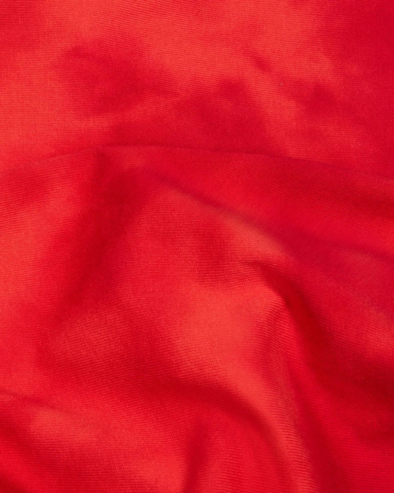 Close-up of the red washed tie-dye cotton fabric on the Patta x Nike NRG T-shirt.