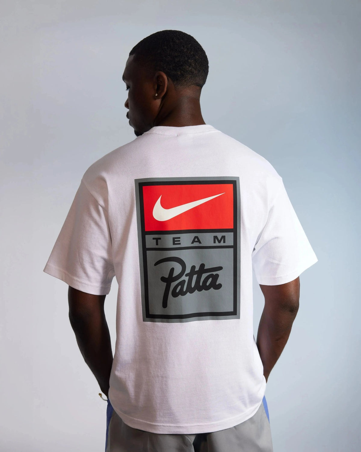 Back view of the white Patta x Nike NRG graphic T-shirt featuring a Team Patta logo badge.