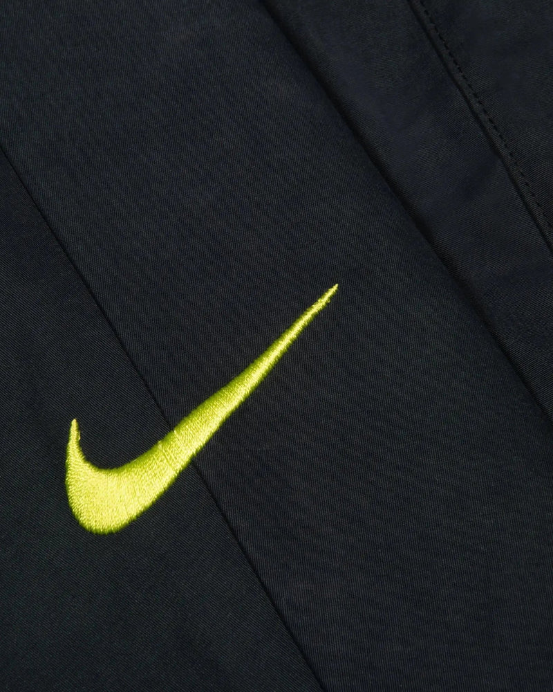 Close-up of the cyber embroidered Nike Swoosh on the black Patta x Nike NRG Track Jacket.