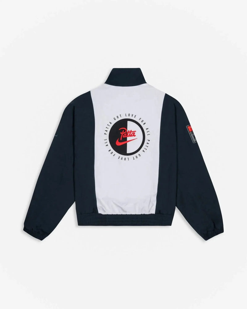 Back view of Patta x Nike NRG Track Jacket in Deep Ocean and White with circular back applique.