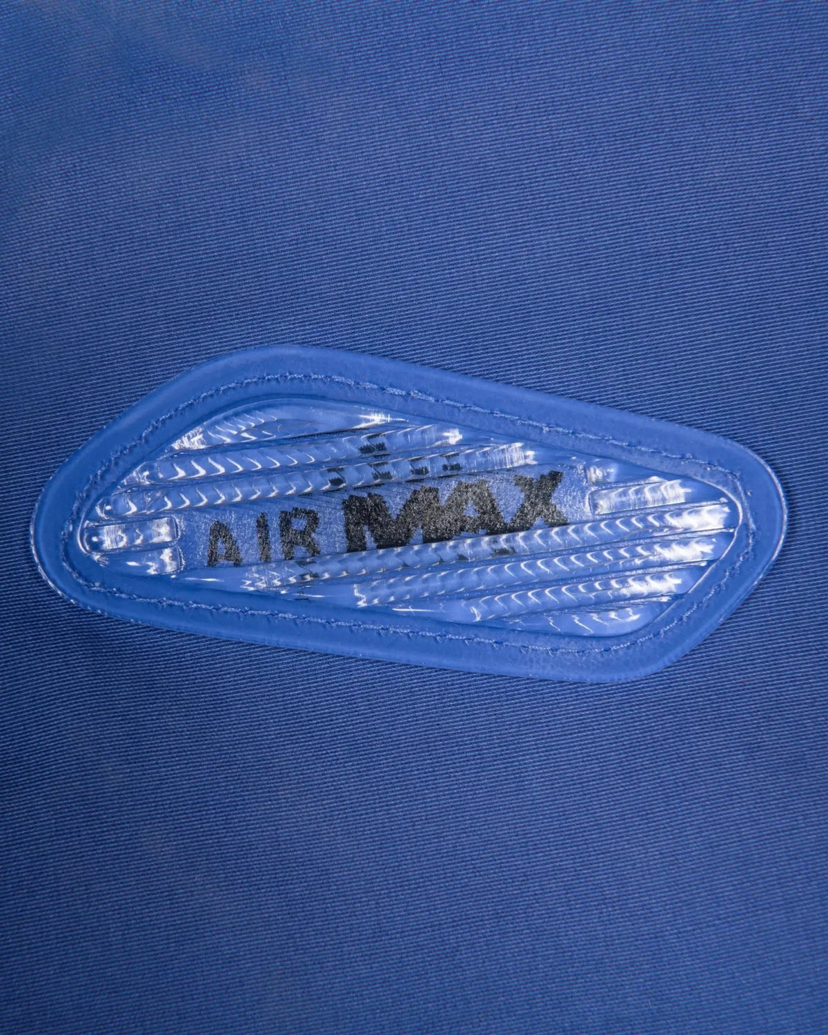 Lenticular Air Max bubble trim detail on the sapphire blue Patta x Nike NRG Track Jacket.