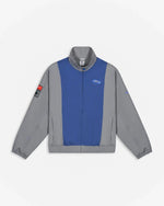 Front view of the Patta x Nike NRG track jacket in particle grey with sapphire blue paneling.