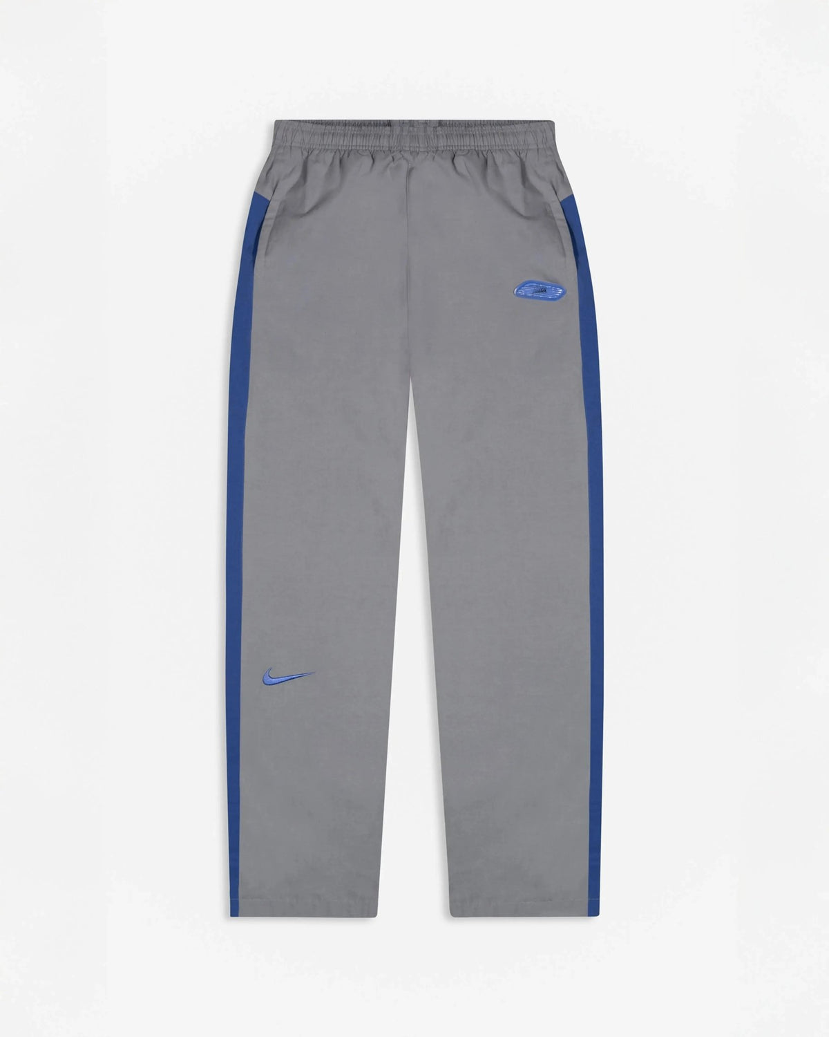 Patta x Nike NRG track pants in particle grey featuring sapphire blue side stripes and embroidered swoosh.