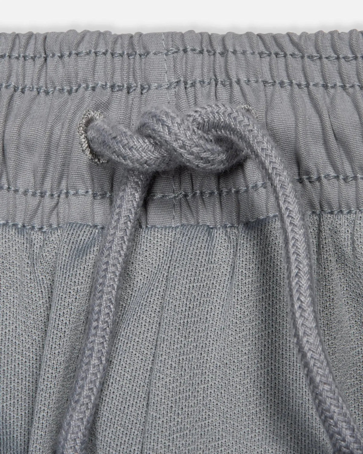 Drawstring and elastic waistband detail on the Patta x Nike NRG Track Pant in Particle Grey.