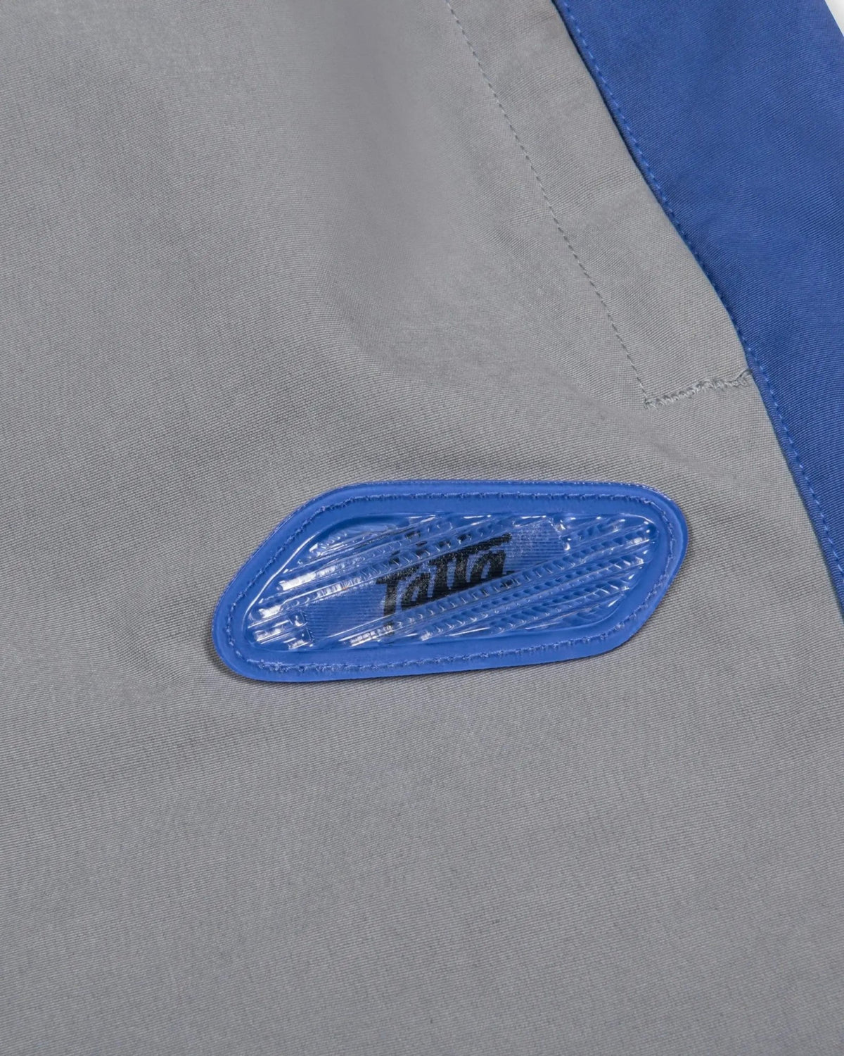 Lenticular blue Air Max bubble badge on the Patta x Nike NRG Track Pant in Particle Grey.