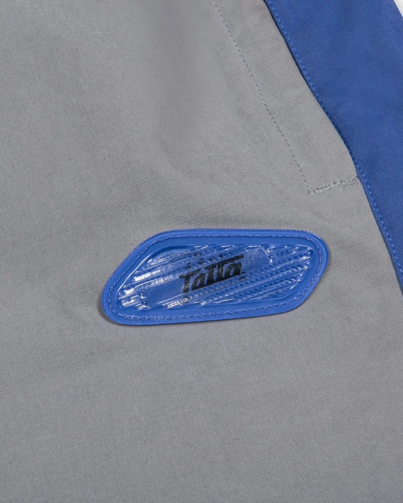 Lenticular blue Air Max bubble badge on the Patta x Nike NRG Track Pant in Particle Grey.