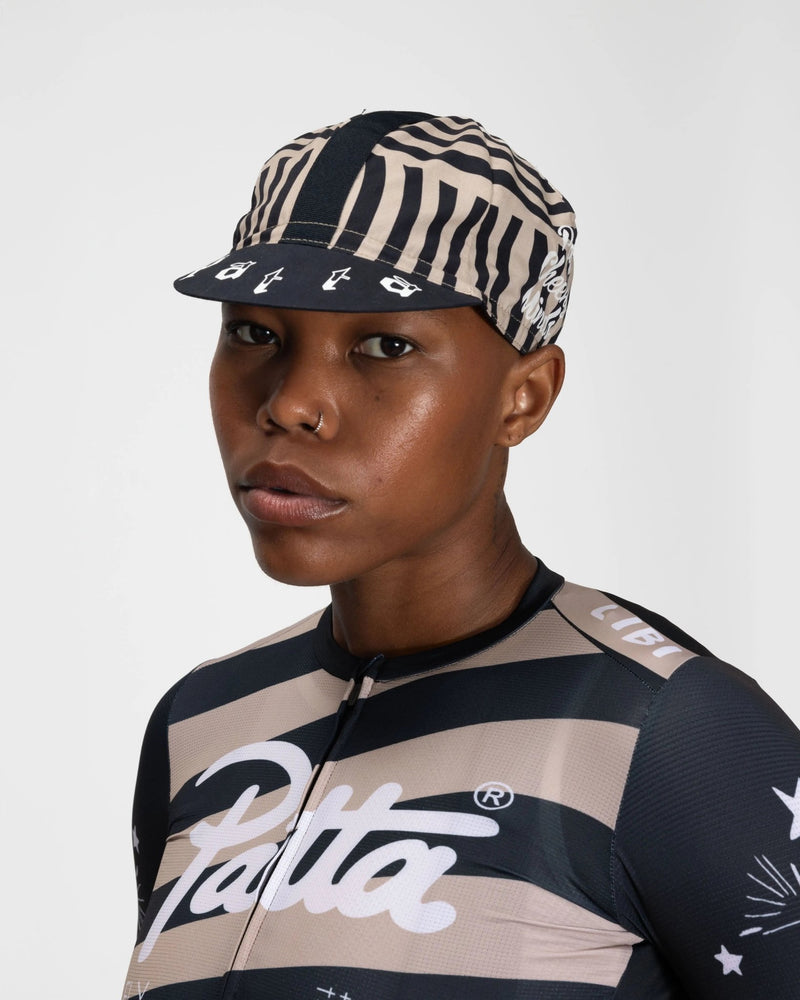Patta x Rapha Cap II cycling cap in black and stone pattern worn by a model.