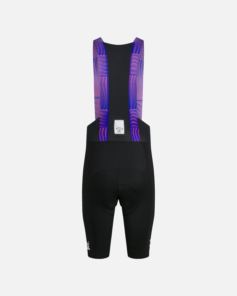 Back view of Patta x Rapha Men's Pro Team Bib Shorts in black with graphic pink and blue straps.