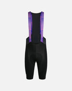Back view of Patta x Rapha men's bib shorts in black with flamingo pink and royal blue mesh straps.