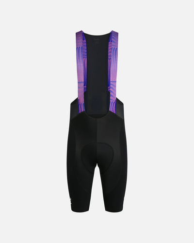 Back view of Patta x Rapha men's bib shorts in black with flamingo pink and royal blue mesh straps.