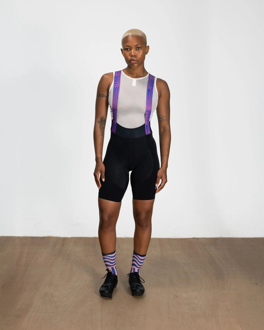 Front view of model wearing Patta x Rapha women's Pro Team bib shorts in black with printed straps.