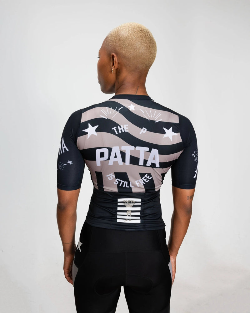 Back view of a model wearing the Patta x Rapha Women's Pro Team Training Jersey in black and stone.