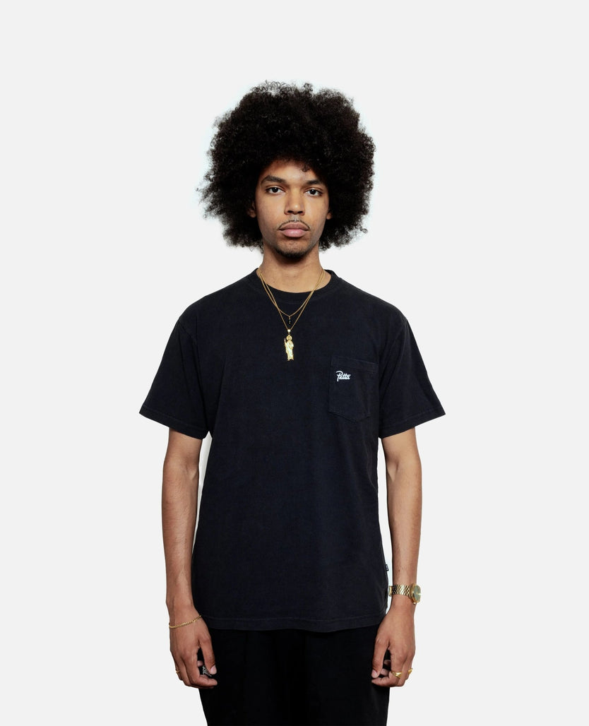 Front view of a model wearing the black Patta Soundsystem x Tom Trago washed pocket t-shirt.